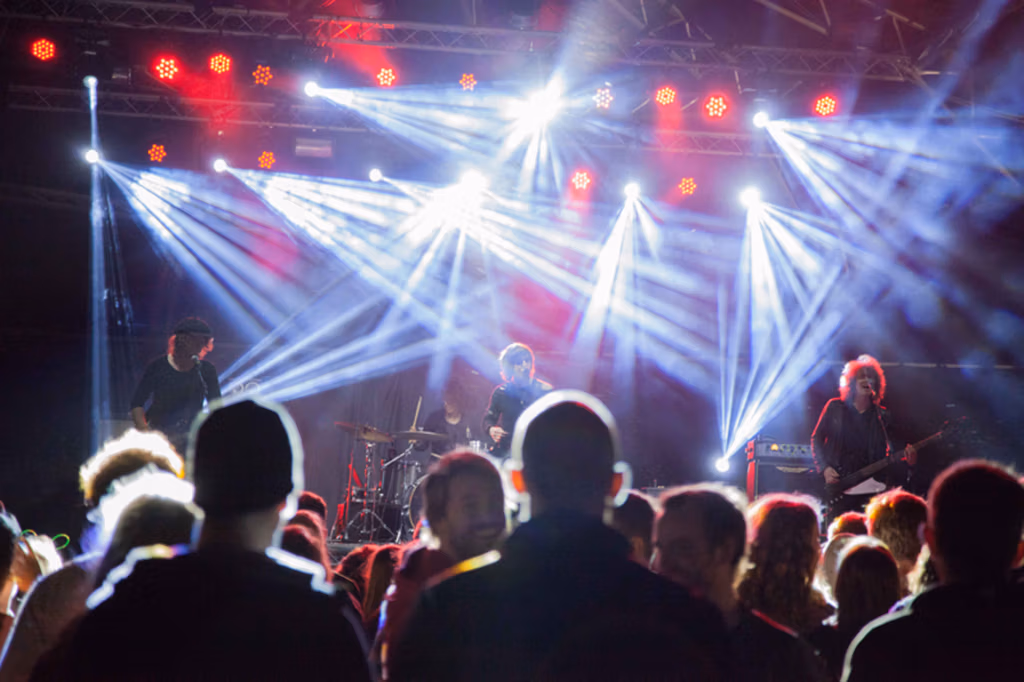 back of audience viewing music stage with lightship